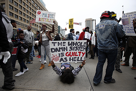 Marchers block the Pratt Street after a march to City Hall for Freddie Gray, Saturday, April 25, 2015 in Baltimore. Gray died from spinal injuries about a week after he was arrested and transported in a police van. (AP Photo/Alex Brandon)