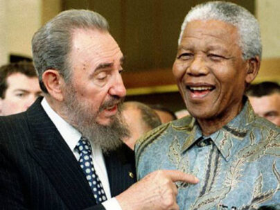 ABOVE PHOTO: Cuban leader Fidel Castro, left, shares a laugh with the late South Africa President Nelson Mandela at the World Trade Organization held in 1998 in Geneva. Mandela and Castro said in separate speeches that the global trading system had failed to achieve its goals of bringing a higher standard of living to many developing countries. (AP Photo/PATRICK AVIOLAT)