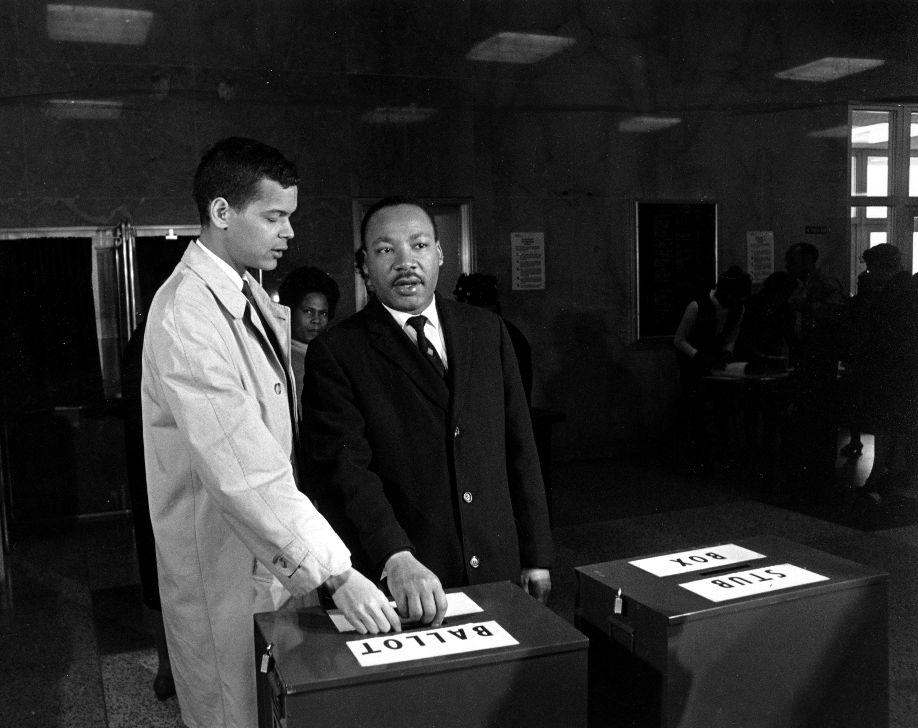 This is a photo of Julian Bond and Dr. Martin Luther King Jr. casting their ballots to fill Bond's vacant seat in the U.S. House of Representatives in Atlanta, Ga., on Feb. 23, 1966.  Bond was refused his seat in congress because of his endorsement of a statement which charged th U.S. with committing aggression in Vietnam.  (AP Photo)
