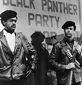 Black Panther national chairman Bobby Seale, wearing a Colt .45, left, and Huey Newton, defense minister with a bandoleer and shotgun. Undated photo. (AP Photo/S.F. Examiner)