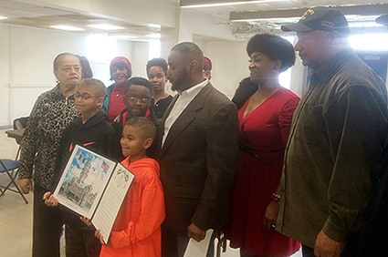 Harold Johnson’s family and friends, including Judge Jackie Frazier-Lyde (in red), Councilman Curtis Jones and Rev. John Roberts, Johnson’s son, celebrate the now renamed Harold Johnson Boxing Gym at the Kendrick Recreation Center. (Photo: Chris Murray)