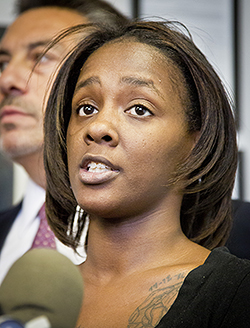 Kimberly Ballinger, the domestic partner of Akai Gurley and mother of his toddler daughter, hold a press conference, Thursday, Jan. 29, 2015, in New York.  Ballinger filed a lawsuit seeking $50 million against the city, the New York Police Department and officers Peter Liang and Shaun Landau in the shooting death of Akai in a Brooklyn housing project stairway.  (AP Photo/Bebeto Matthews)
