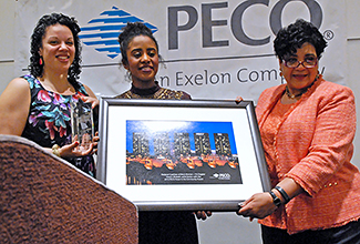 Shaleah Lache Sutton (center) founder of Uniquely You Summit, receives the PECO Power in the Community Award from Tiffany Tavarez and Ramona Riscoe Benson of PECO. (Photo by Bill Z. Foster)