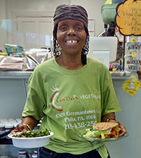 Linda Smith, owner of Linda’s Vegetarian Village getting ready to serve her kale salad and vegetarian BLT on flatbread.