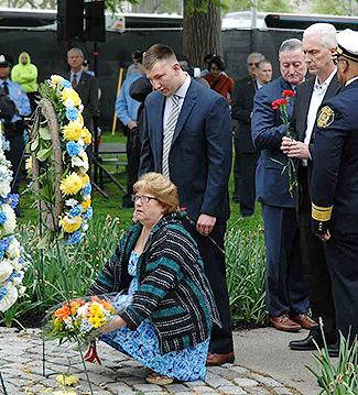 Family Tribute… Denise and Walter DeWitt IV, wife and son of Officer Walter DeWitt III, a 33-year veteran and highly decorated member of the Philadelphia Police Department, who died last June from complications of surgery after a work-related injury…pay their respects at the Living Flame Memorial Service today.  (Photo by Tony Webb, City of Philadelphia/ Office of the City Representative)