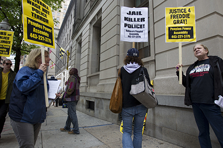 Demonstrators protest outside of the courthouse during the trial of Officer Edward Nero, one of six Baltimore city police officers charged in connection to the death of Freddie Gray, Thursday, May 12, 2016, in Baltimore Md. Nero faces assault, misconduct in office and reckless endangerment charges. (AP Photo/Jose Luis Magana)