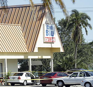Crime scene tape surrounds the Club Blu nightclub, the scene of a deadly shooting, Monday, July 25, 2016, in Fort Myers, Fla.  Gunfire erupted at the nightclub hosting a swimsuit-themed party for teens.  (AP Photo/Lynne Sladky)