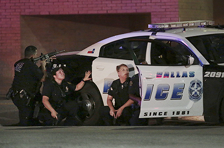 Dallas police respond after shots were fired during a protest over recent fatal shootings by police in Louisiana and Minnesota, Thursday, July 7, 2016, in Dallas. Snipers opened fire on police officers during protests; several officers were killed, police said. (Maria R. Olivas/The Dallas Morning News via AP)