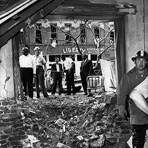 This large crater is the result of a bomb that exploded near a basement room of the Sixteenth Street Baptist Church in Birmingham, Ala. on September 15, 1963, killing four black girls. All the windows were blown out of the building just behind police and emergency workers. (AP Photo)