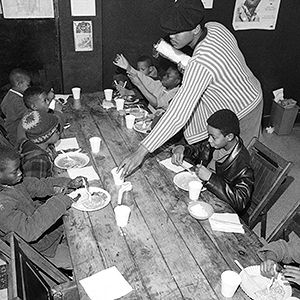 Brad Jones, wearing cap, member of the Philadelphia Black Panthers Organization, helps serve breakfast to youngsters, March 19, 1970 in Philadelphia, Pa., headquarters. (AP Photo/Bill Ingraham)
