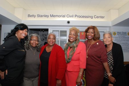 Caption: (all females)--L-R: Nichole Stanley, Dorothy Smith, Catherine Stafford, Velva Smalls, Paula Cropper, Delores Mitchell. Daughters Nichole and Paula join the sisters of Betty Stanley as they pose in front of the newly-named Betty Stanley Memorial Civil Processing Center. 