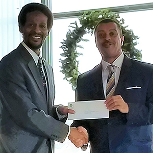 Ken Scott, President of the Beech Companies, photographed with a representative from the Uptown Theater (grant recipient).
