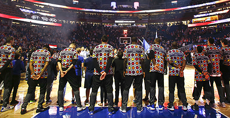 Orlando Magic players stand for the national anthem while wearing colorful shirts in honor of Craig Sager, a television sportscaster who passed away earlier in the week, before an NBA basketball game against the Brooklyn Nets in Orlando, Fla., on Friday, Dec. 16, 2016. (AP Photo/Reinhold Matay)