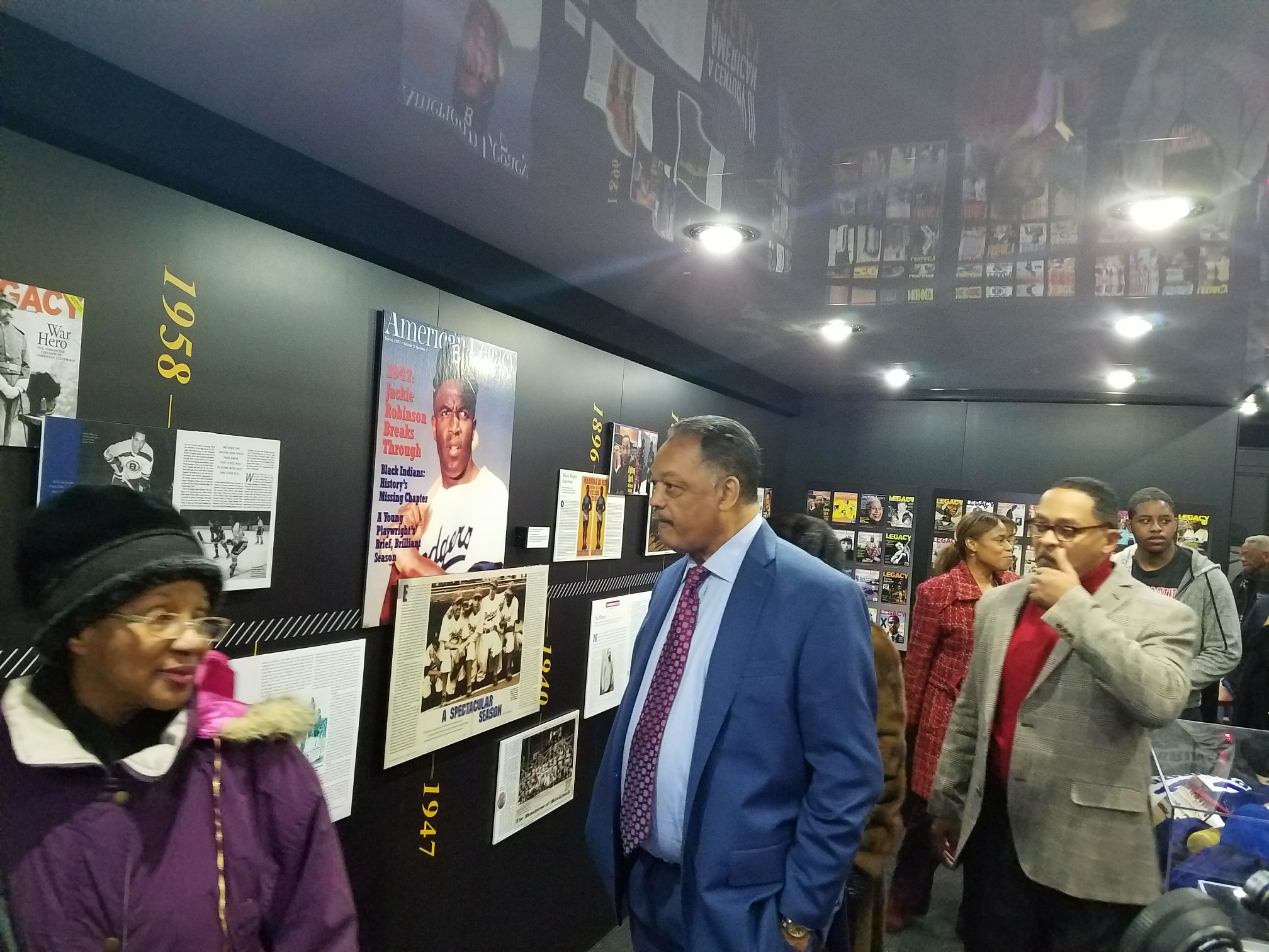 Rev. Jesse Jackson and other visitors tour the mobile truck exhibition.